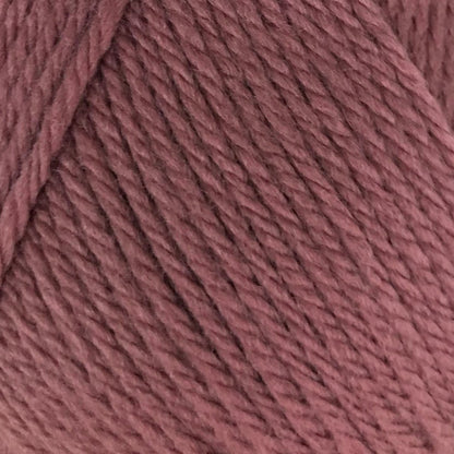 Ball of pink yarn with a label on a white background