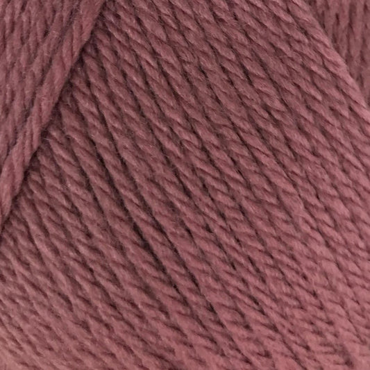 Ball of pink yarn with a label on a white background
