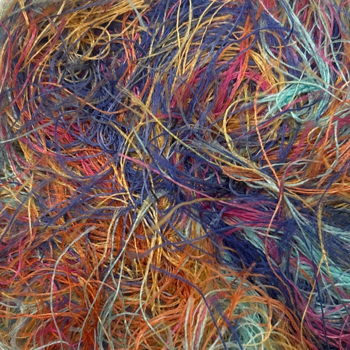 Multicolored skein of yarn on a white background