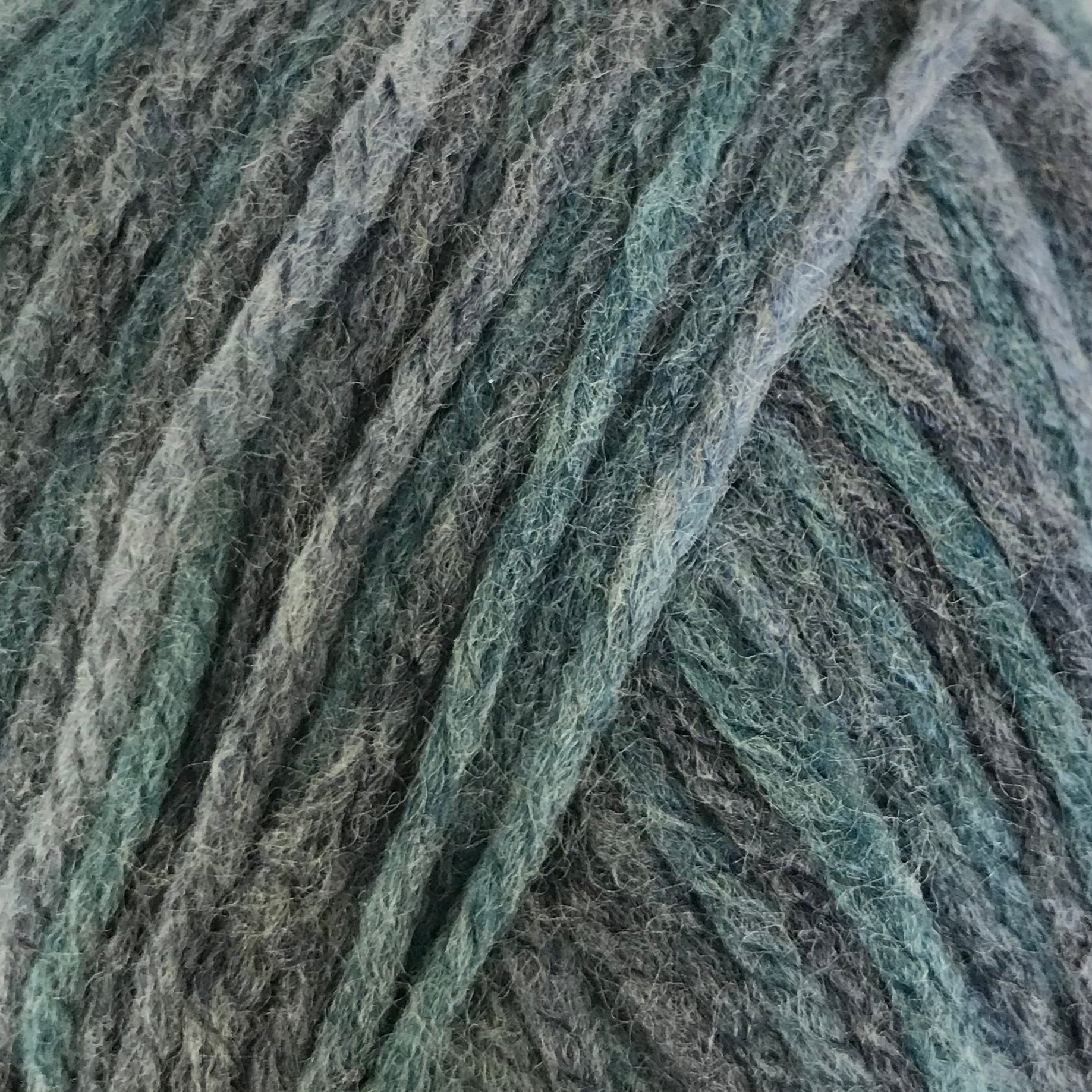 Blue and gray yarn ball with a label on a white background