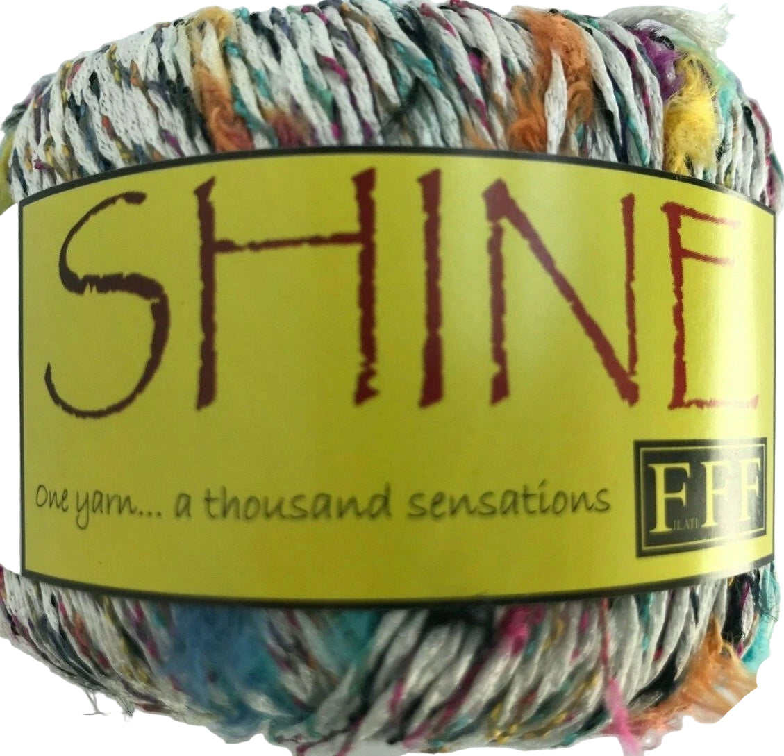 Multicolored yarn ball with a yellow label featuring the brand name 'Shine'.