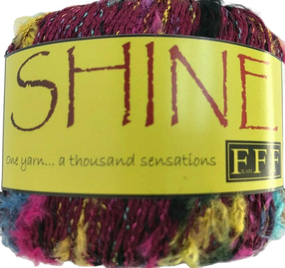 Multicolored yarn ball with a yellow label reading 'SHINE' and 'FBB'.