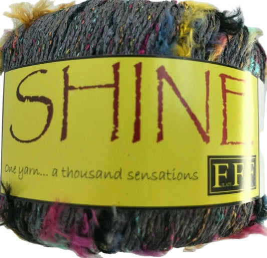 Multicolored yarn with a 'SHINE' label on a white background