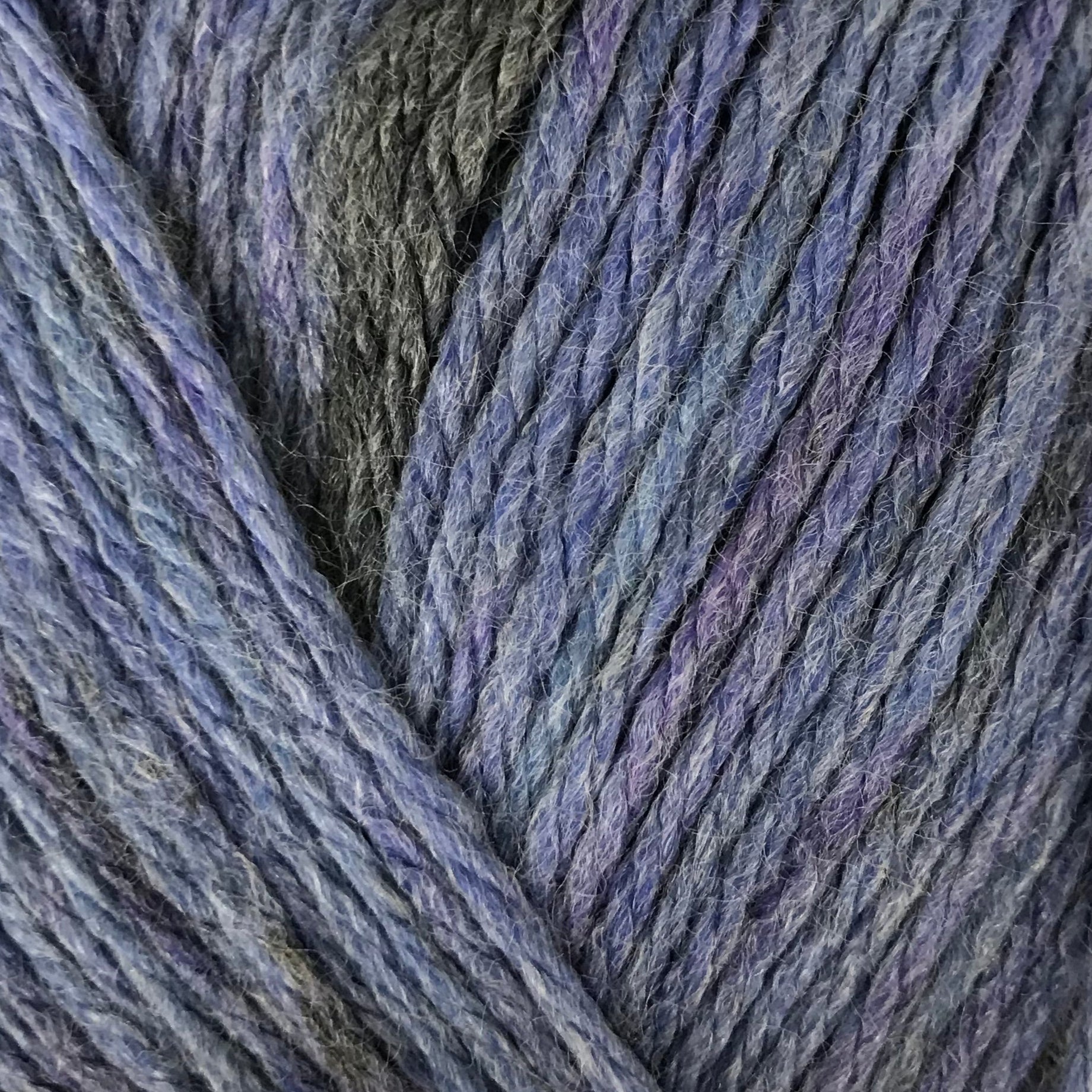 Blue skein of yarn with a label on a beige background