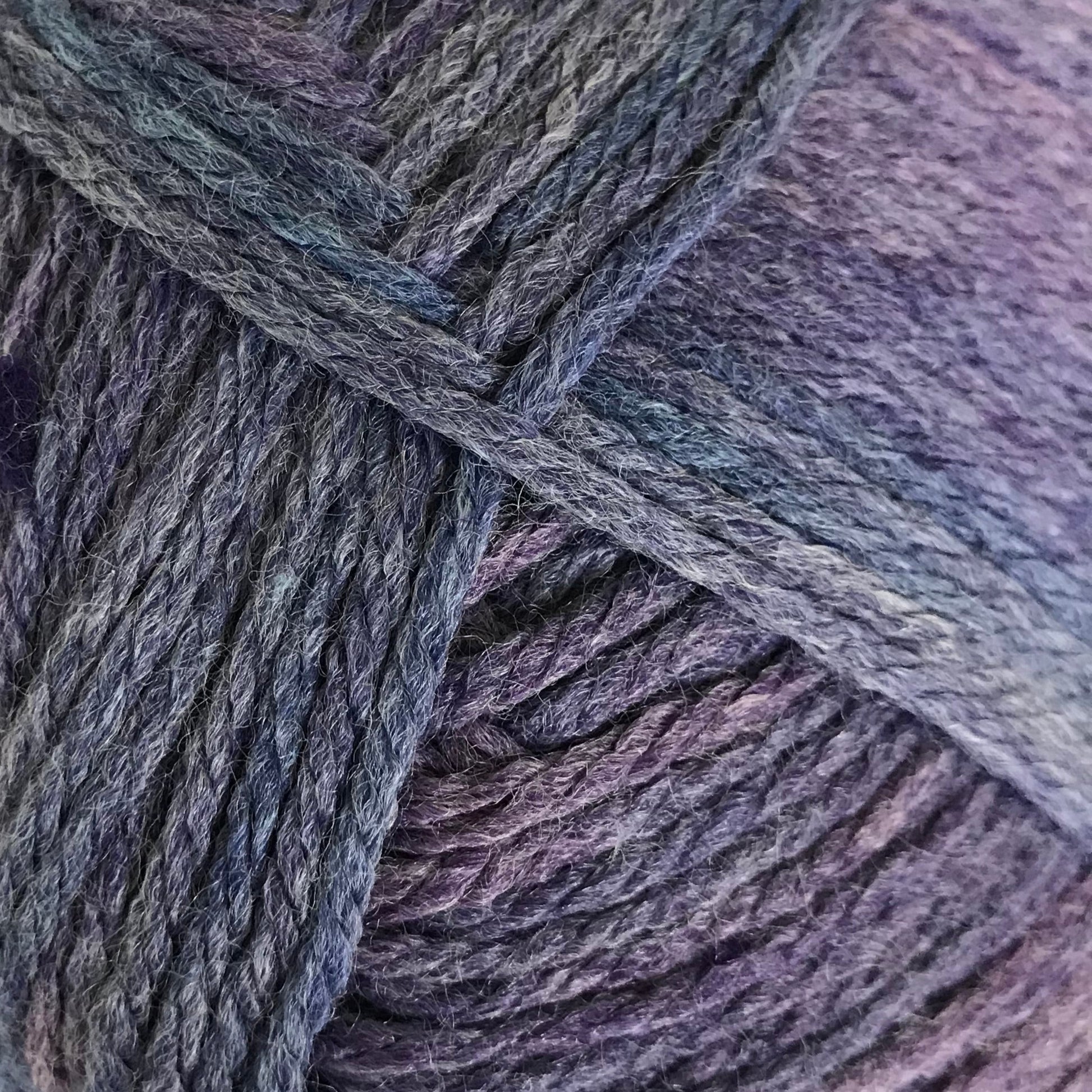 Ball of purple yarn on a light background