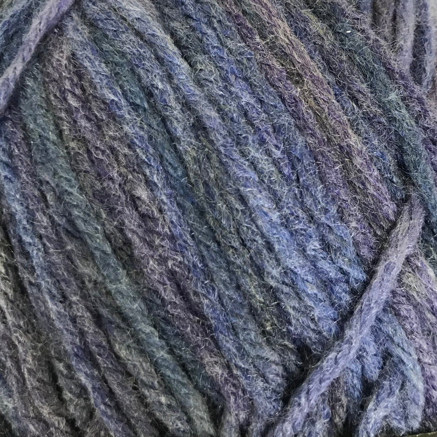 Blue skein of yarn with a label on a light background