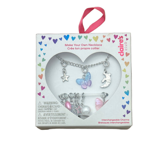 Delaire's Club necklace kit with charms in a heart-shaped box on a white background