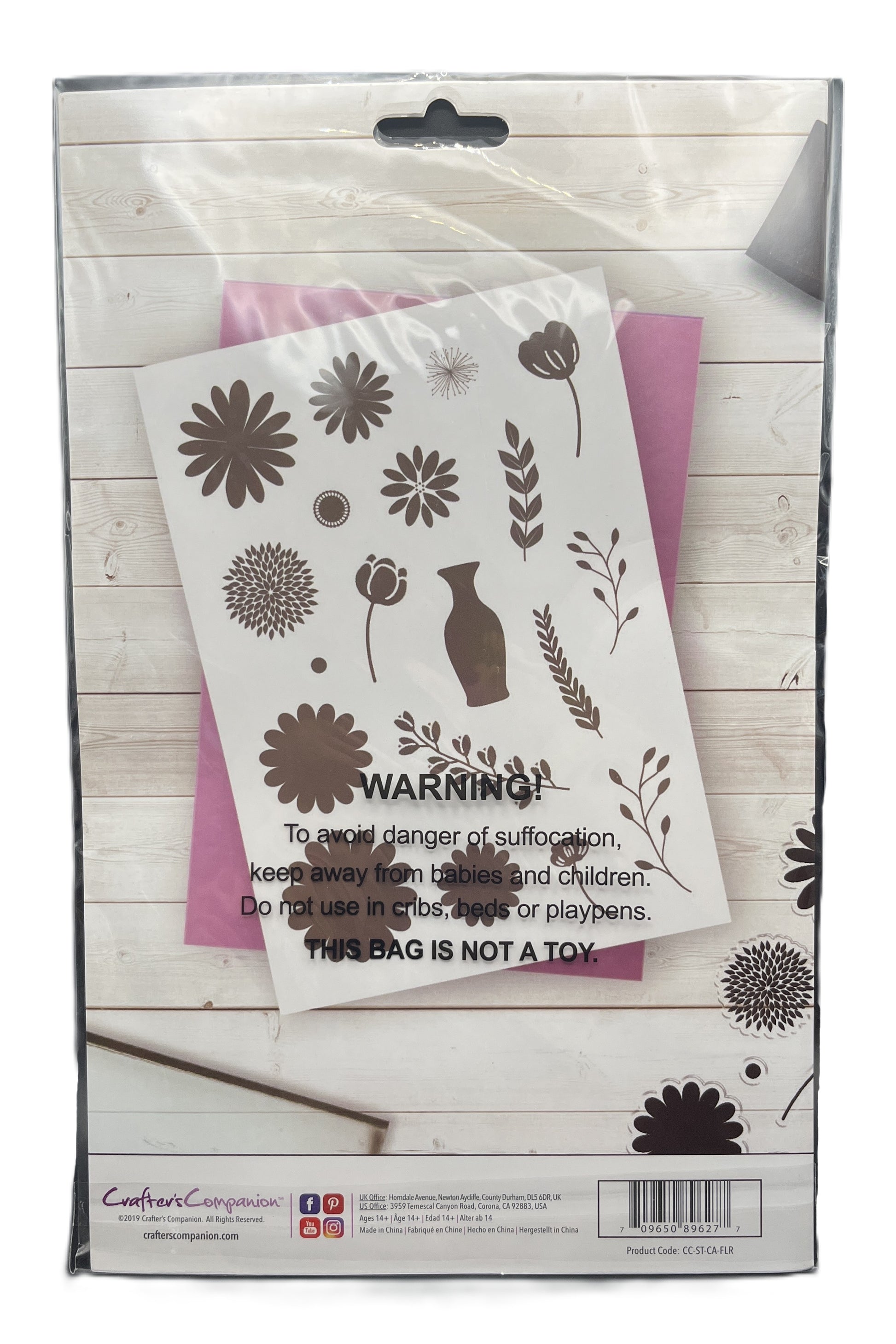 Floral design stencils in a packaging with warning label on a wooden surface