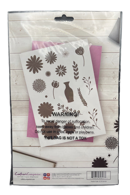 Floral design stencils in a packaging with warning label on a wooden surface