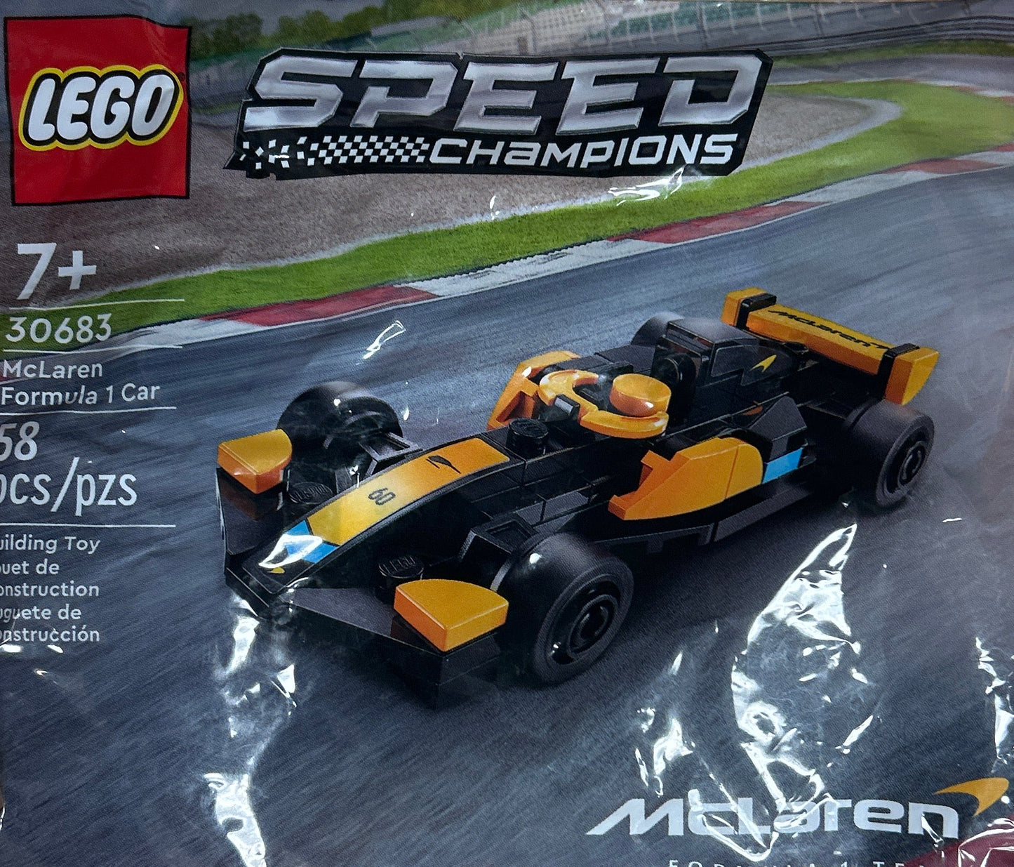 Plastic-wrapped LEGO Speed Champions toy car package on a wooden surface
