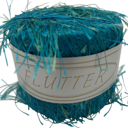 Blue glitter yarn ball with a label on a white background