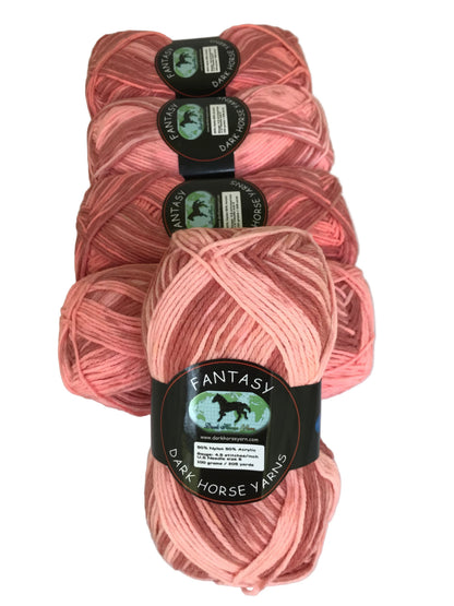 Pink yarn skeins with labels on a white background