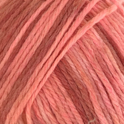 Ball of pink yarn with a label on a white background