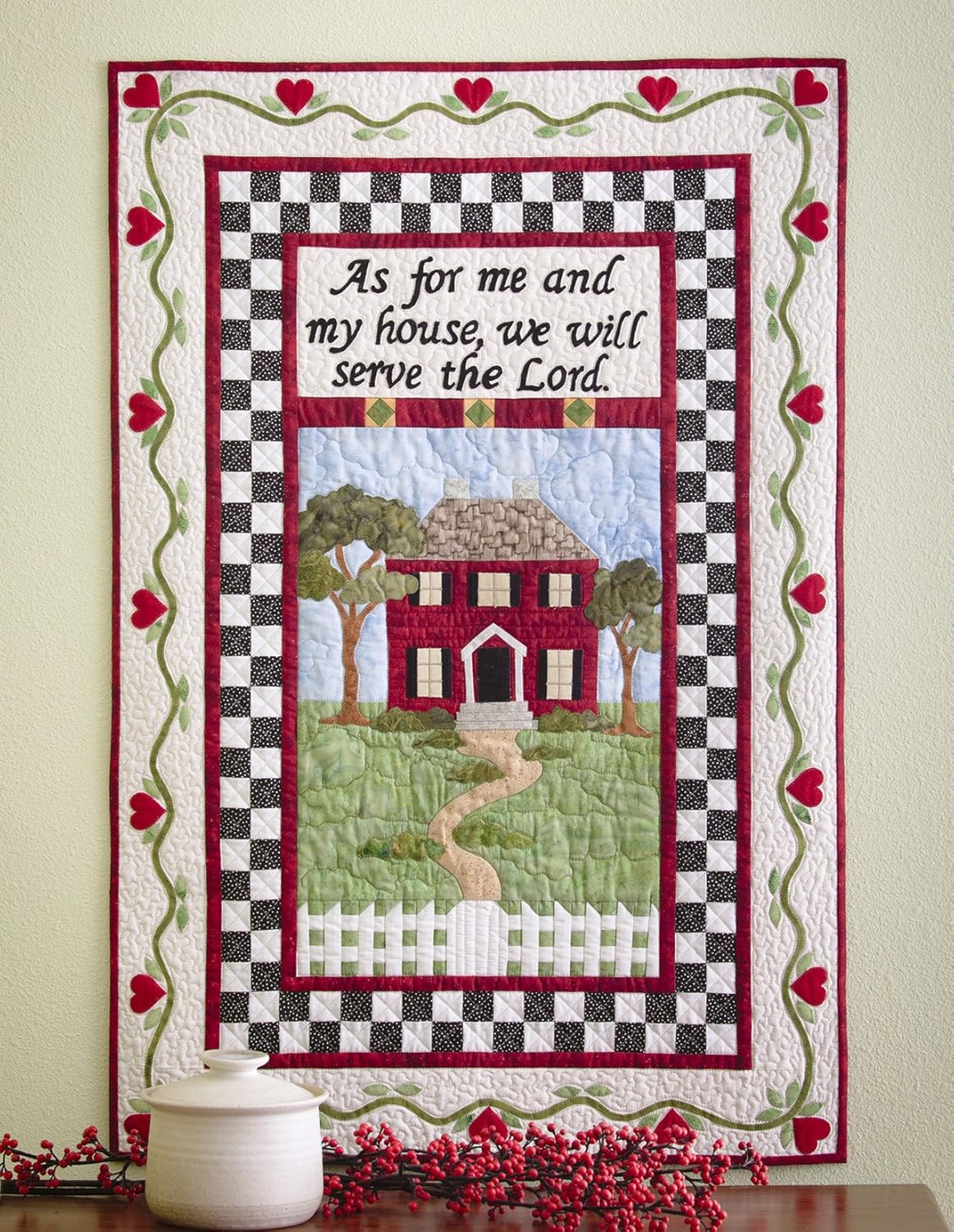 Quilt with a house illustration and text on a wall