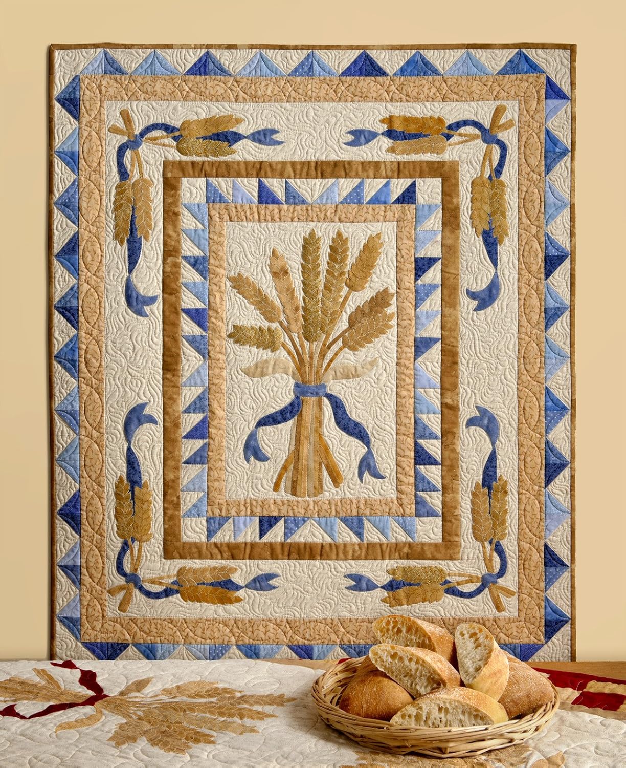 Quilt with decorative border and central design, featuring a basket of bread on a table.