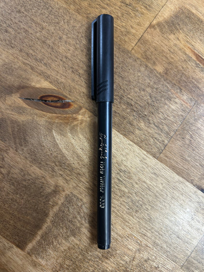 Black pen on a wooden surface