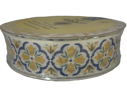 Roll of floral-patterned ribbon on a white background
