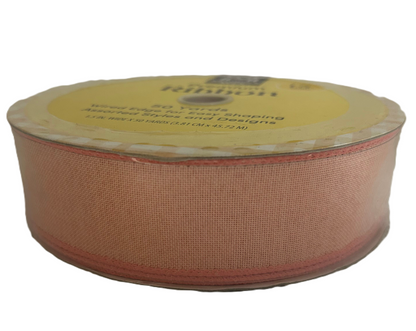 Roll of pink ribbon with a label on a white background