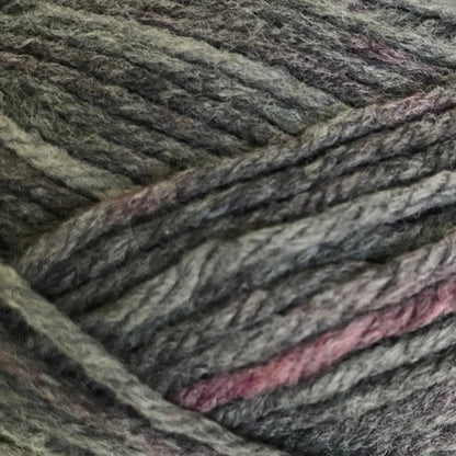 Ball of gray yarn with pinkish tones on a white background