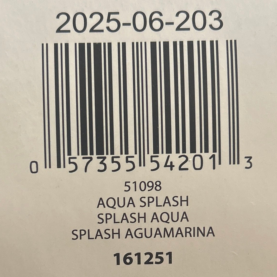 Close-up of a yarn label with product details on a wooden surface