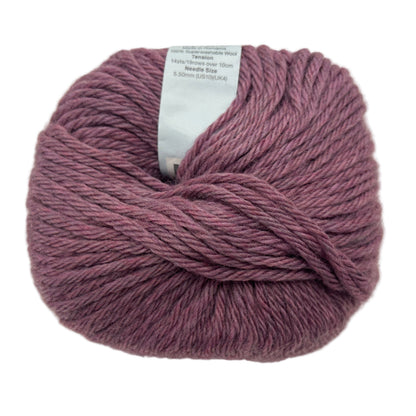 Ball of purple yarn with a label on a white background