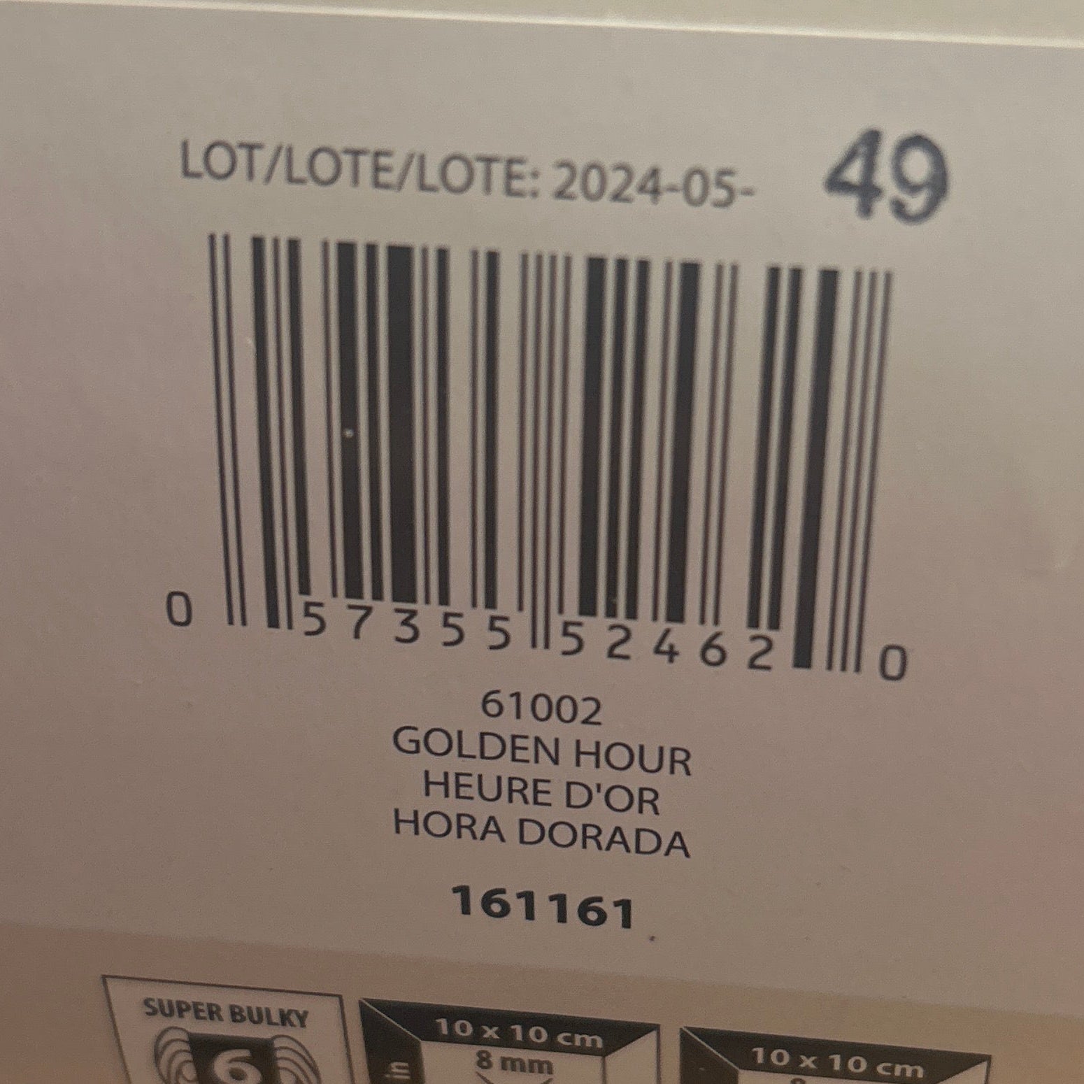 Close-up of a product label with a barcode on a wooden surface