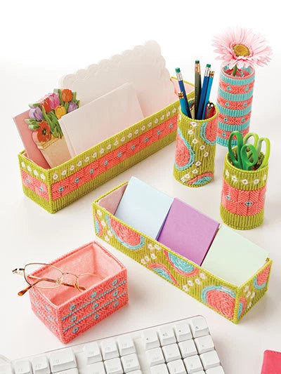 Colorful desk organizer set with stationery items on a white surface