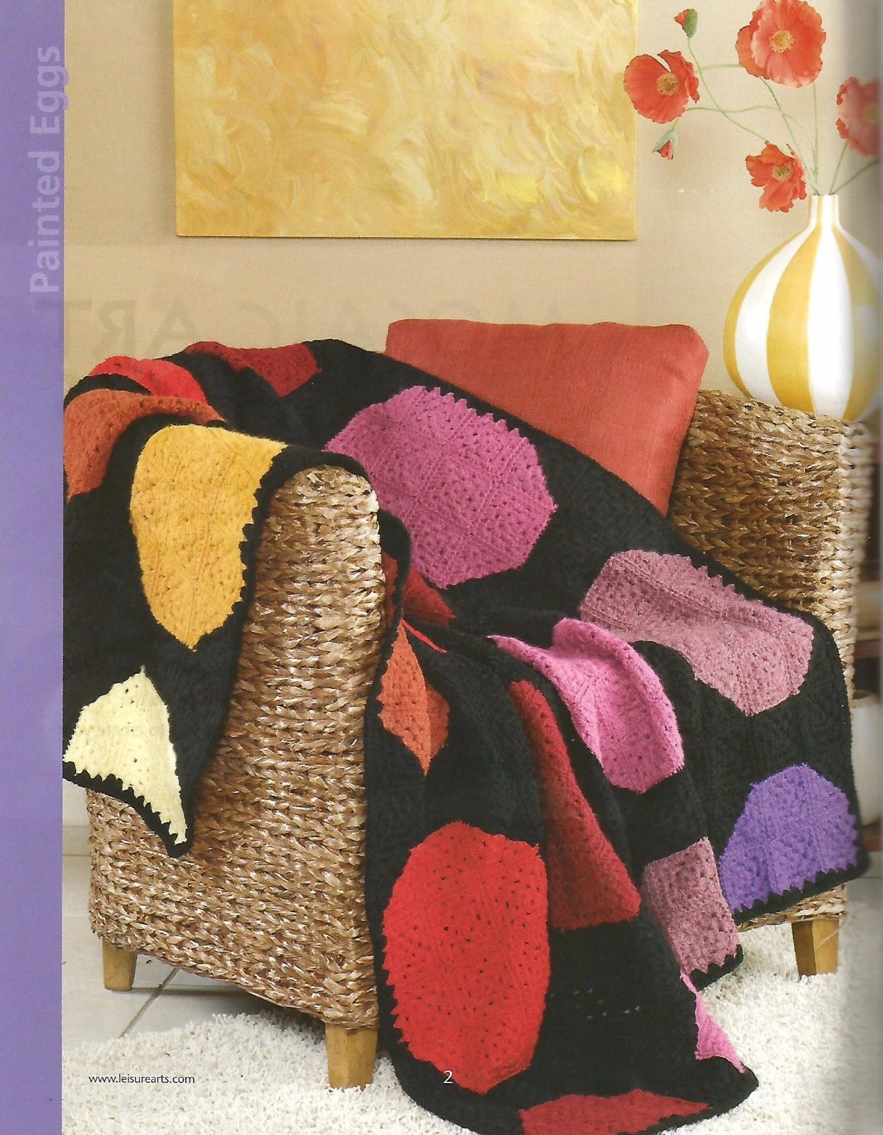 Colorful crocheted blanket draped over a chair in a living room setting.
