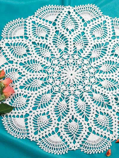 White crocheted doily on a teal background