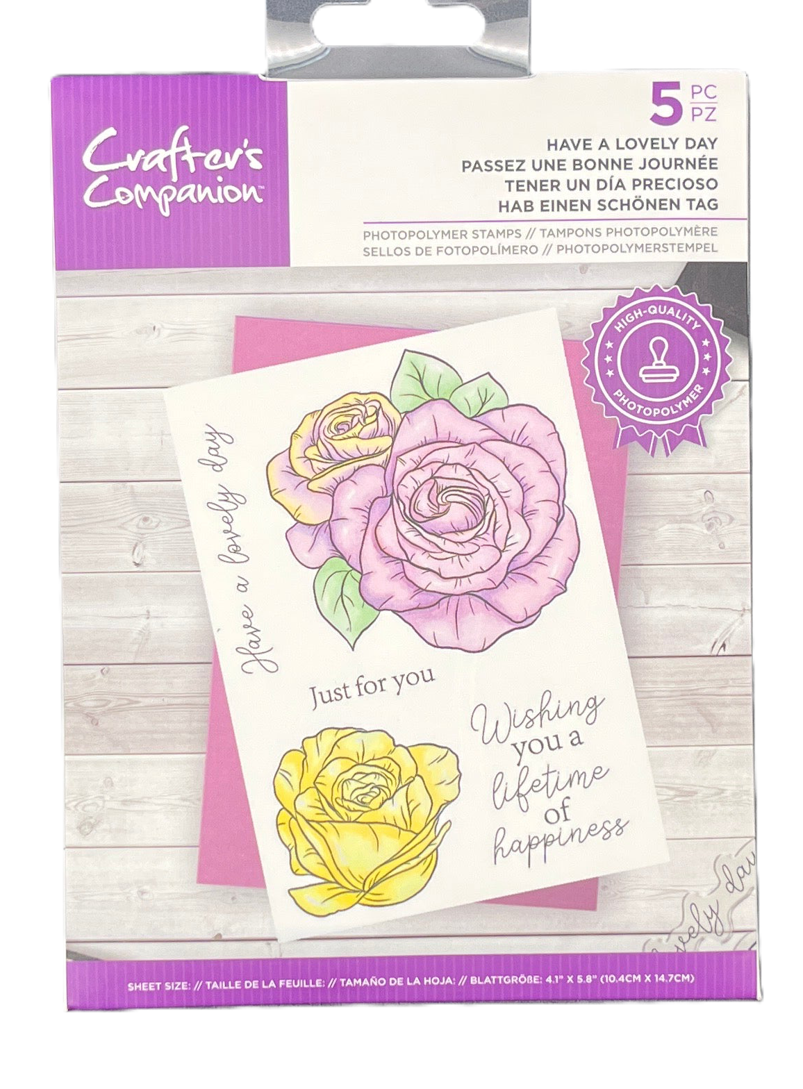 Packaged set of floral stamps with 'Crafters Companion' branding on a wooden surface.