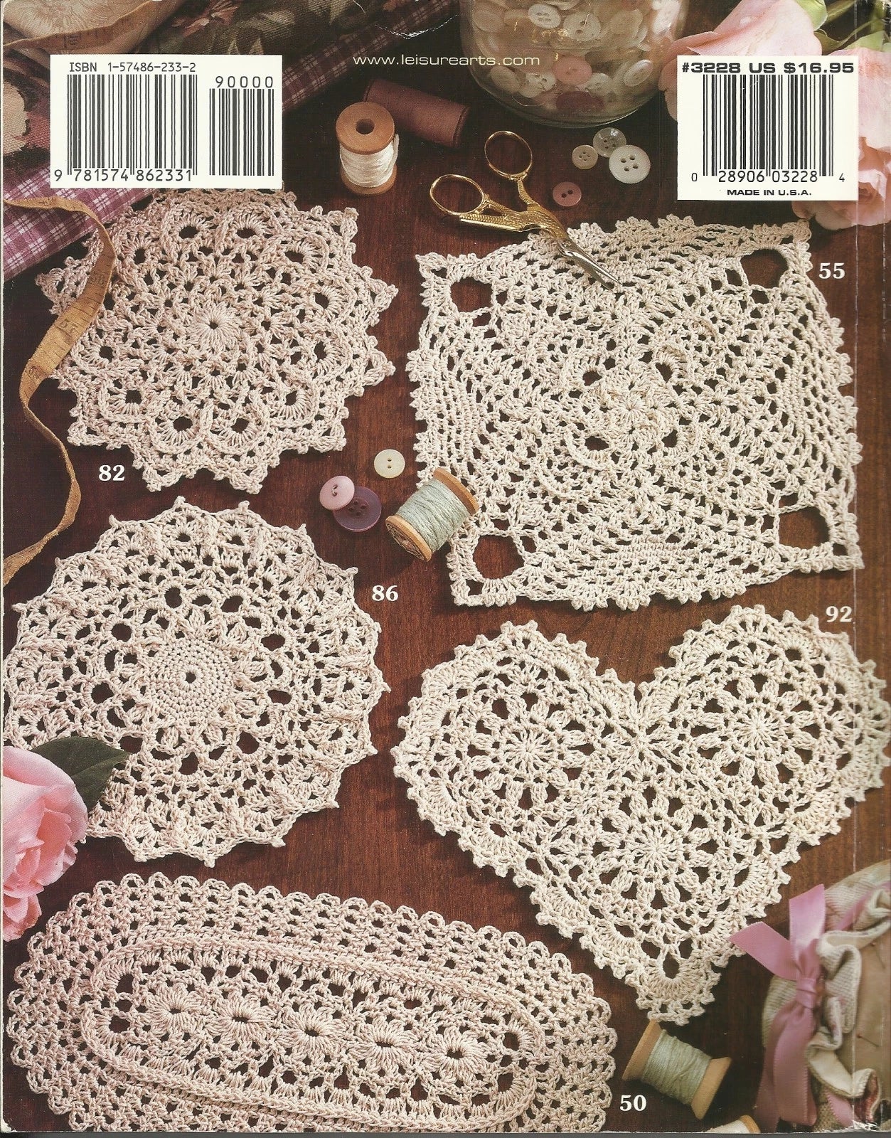 Collection of crocheted doilies on a wooden surface with sewing tools.