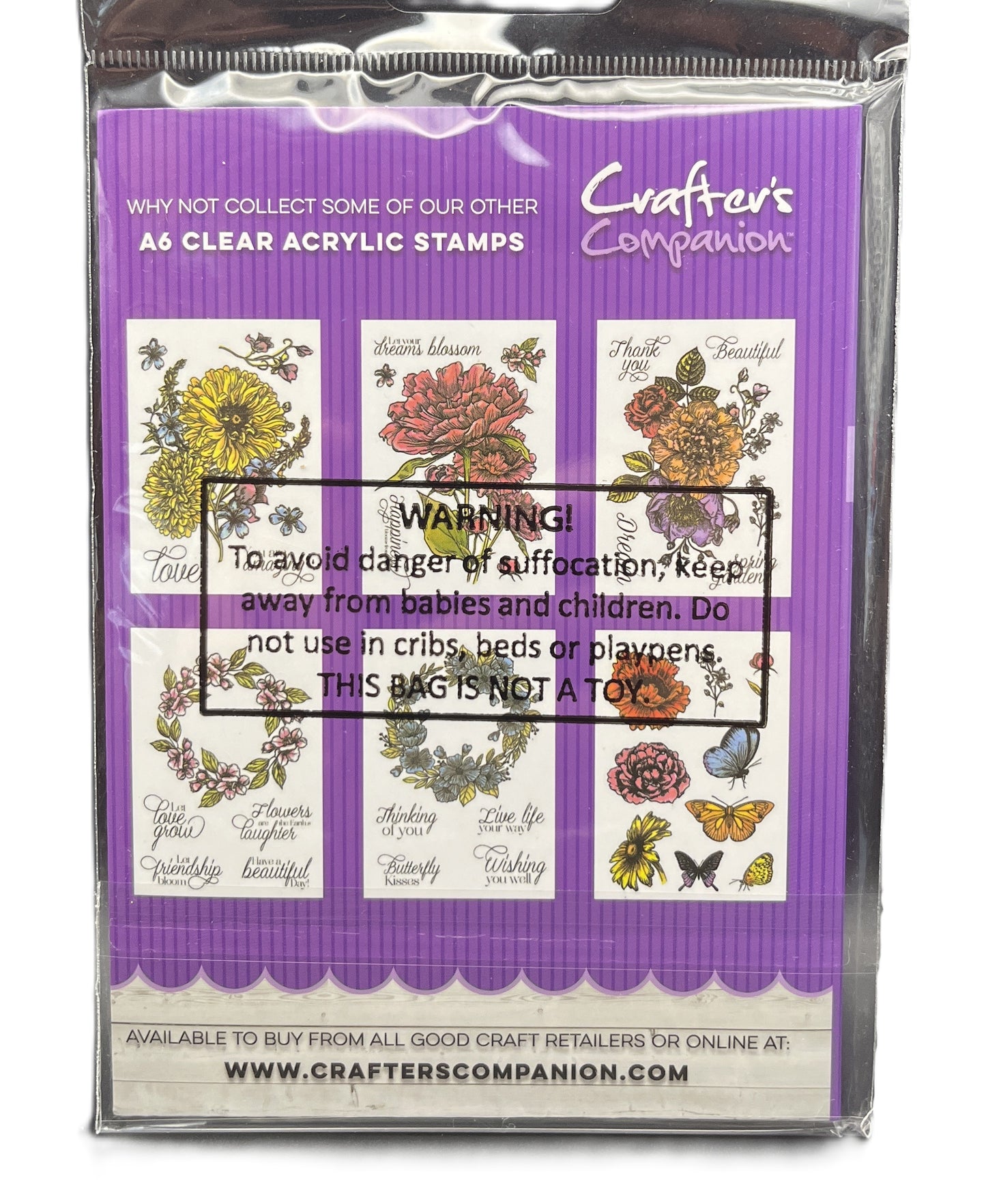 Packaged clear acrylic stamps with floral designs and warning label on purple background