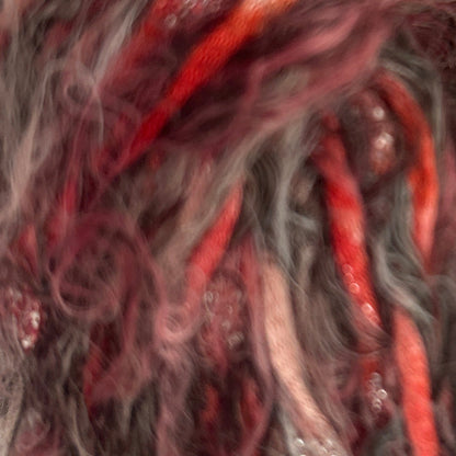 Close-up of red and gray yarn with a textured surface