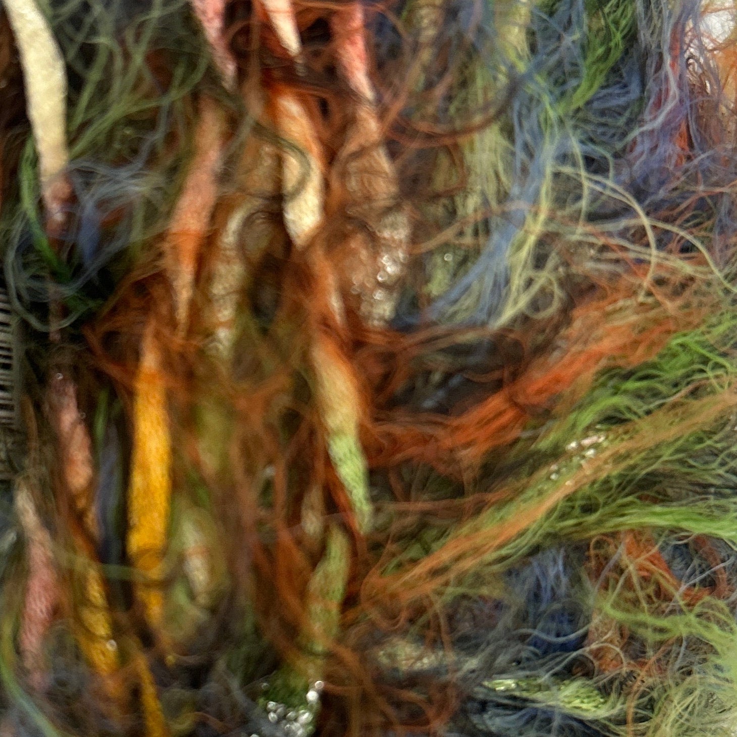 Multicolored yarn ball with a label on a white background