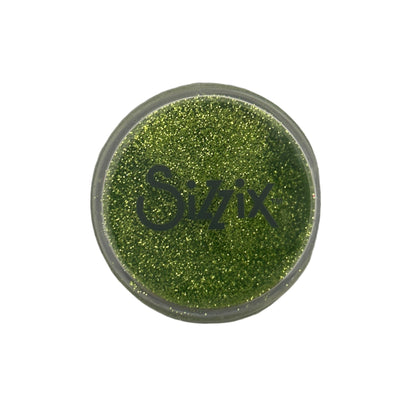 Green glittery powder in a Sizzix container on a white background
