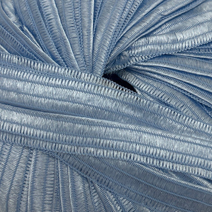 Blue skein of yarn on a beige surface