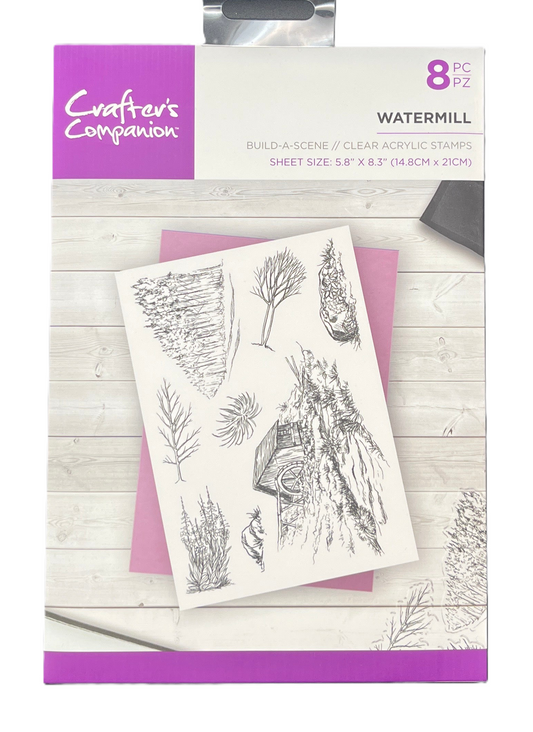 Packaging of Crafter's Companion watermill clear acrylic stamps with nature-themed designs on a wooden surface.