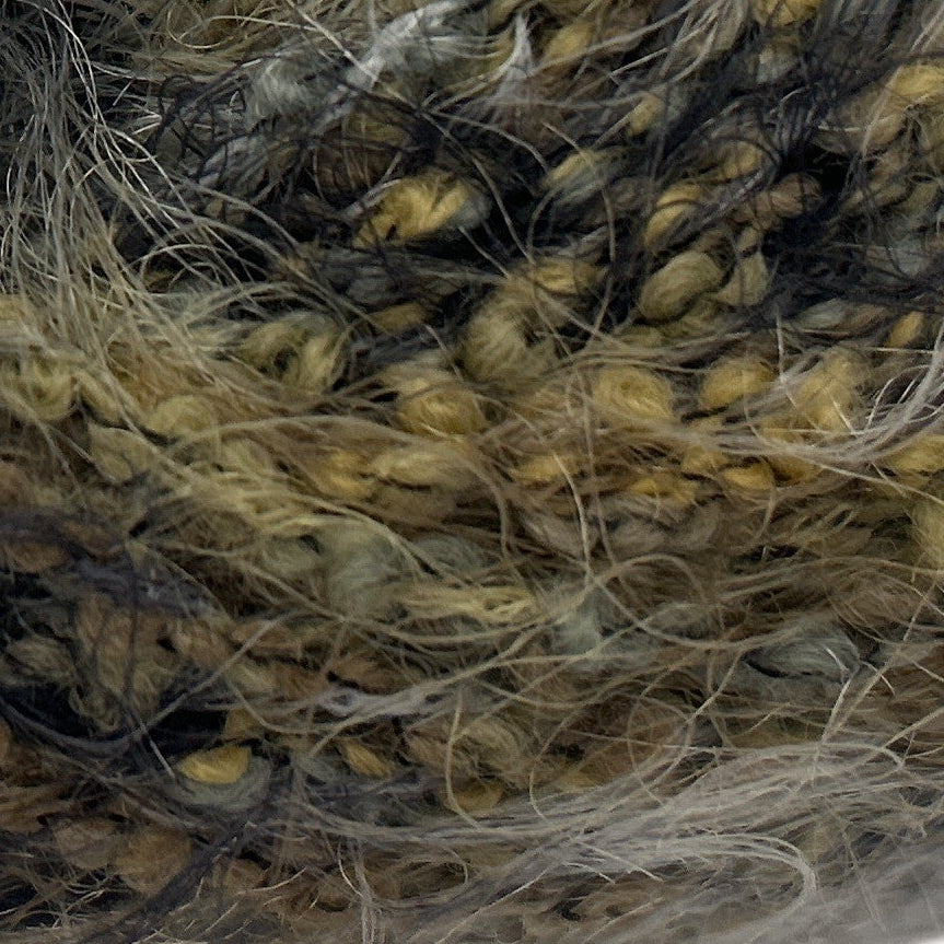 Close-up of textured yarn with brown, beige, and gray colors.