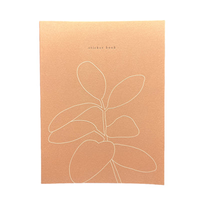 Brown card with white line art of a leaf on a black background