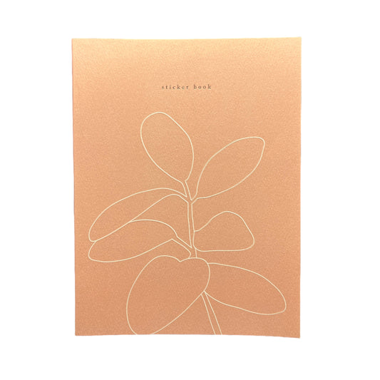 Brown card with white line art of a leaf on a black background