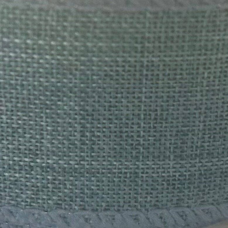 Close-up of a textured green fabric surface