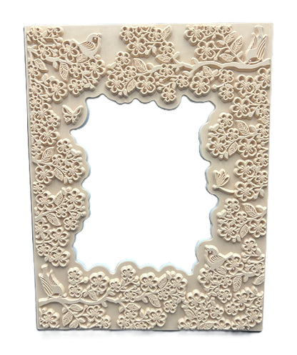 Decorative frame with floral and bird patterns on a white background