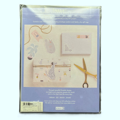 Packaging of stationery items with a cat design on a light blue background