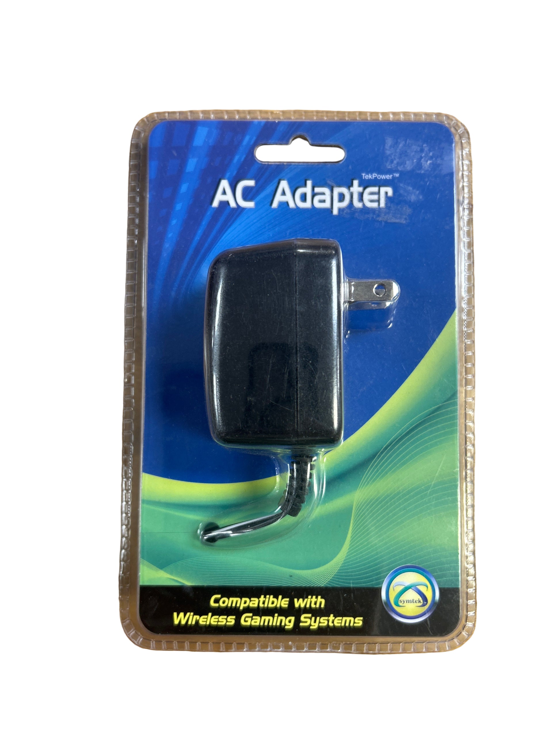 AC adapter on a clear plastic packaging with blue and green design on a wooden surface