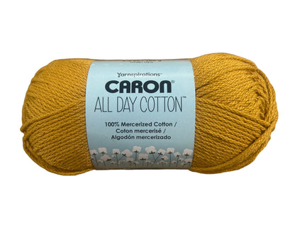Ball of yellow yarn with Caron label on white background