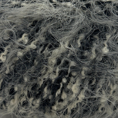 Ball of gray yarn with a label on a white background