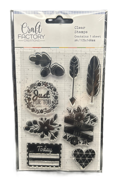 Packaged clear stamps with various designs including feathers, flowers, and text on a white background.