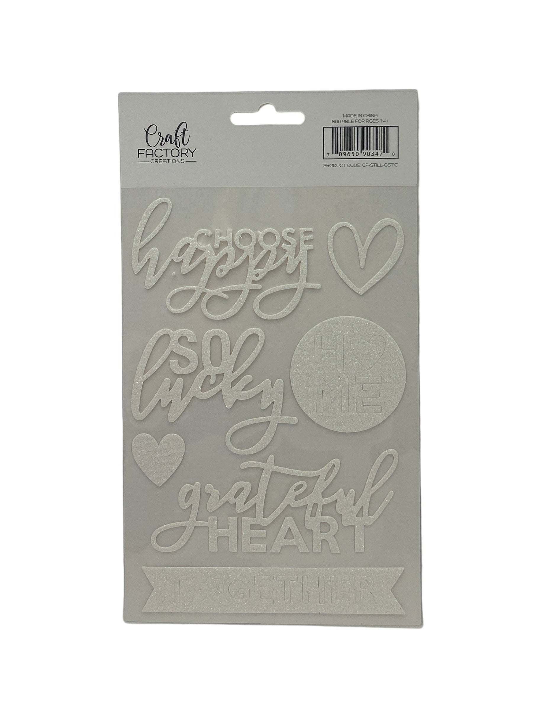 Cardboard cutout with 'happy little grateful heart' text on a white background