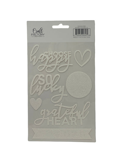 Cardboard cutout with 'happy little grateful heart' text on a white background