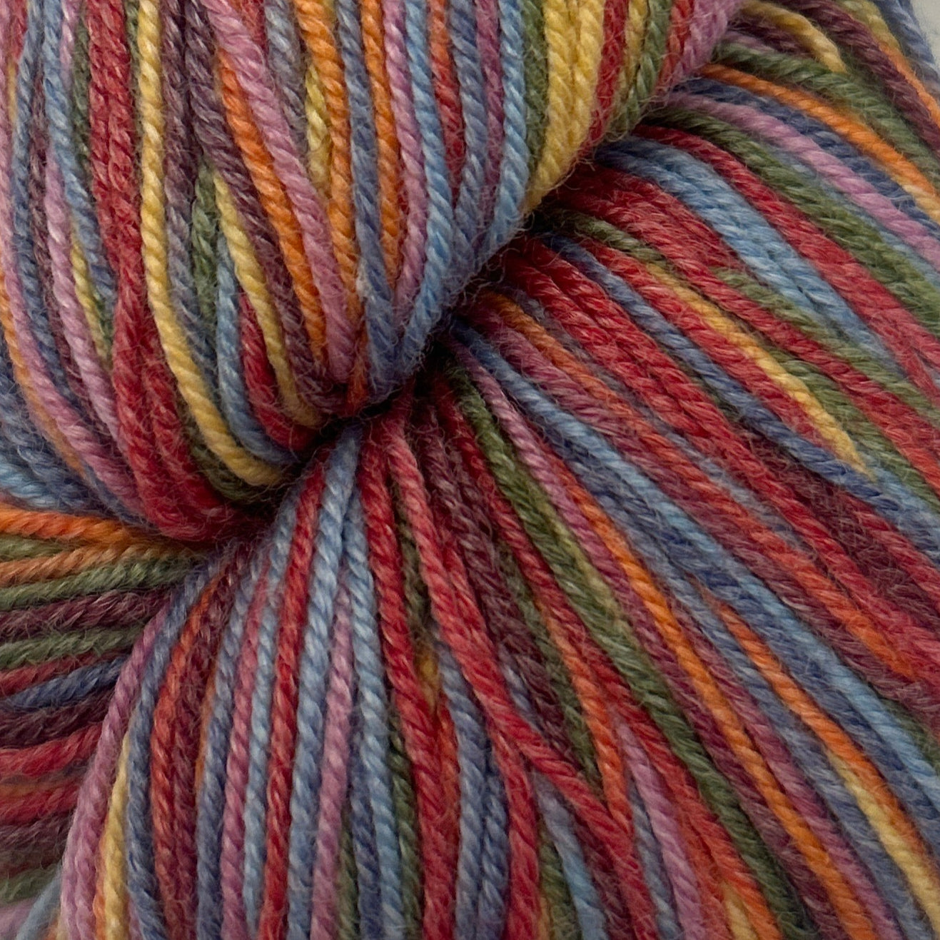 Multicolored skein of yarn on a white background